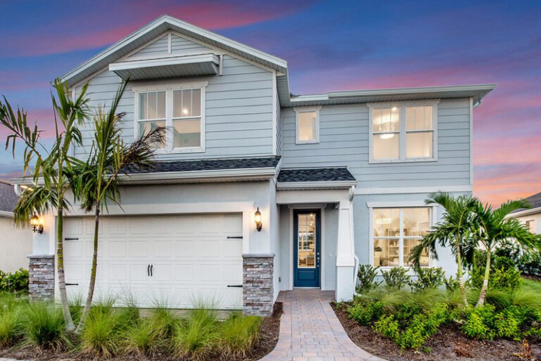 Blue two-story house at dusk with hardie board by Pulte Homes