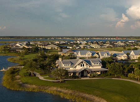 Aerial view of homes clubhouse and lake in Lake Timber neighborhood
