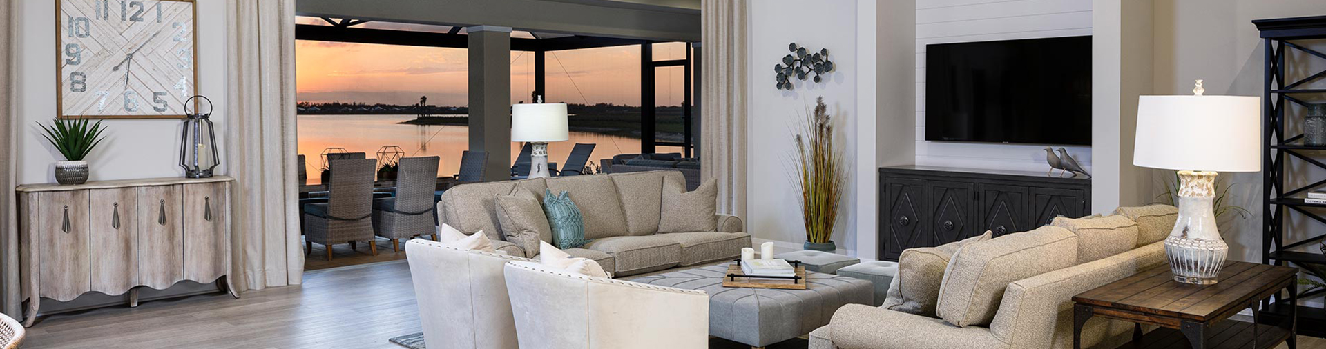 Living Room of custom built home with sliding glass doors open at sunset