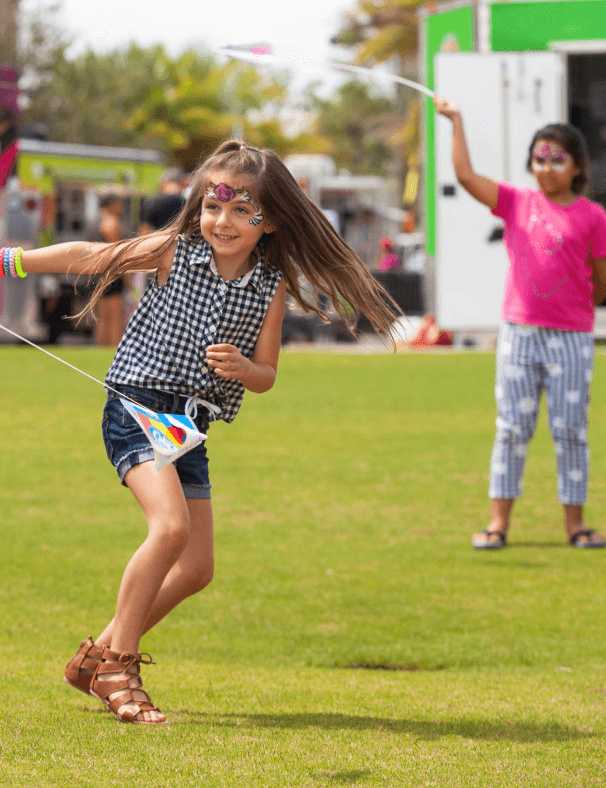 girls playing with flags in a field