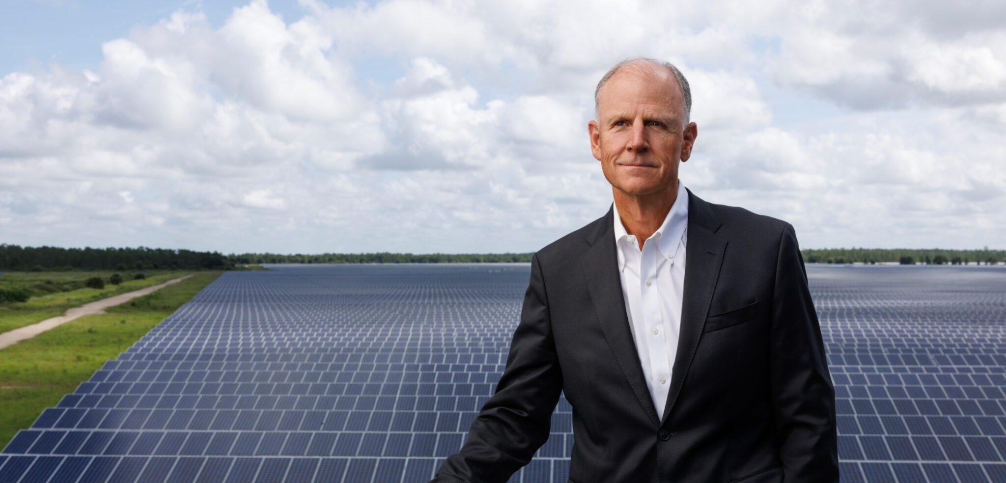 Syd Kitson at Solar Ranch on tower in front of 840-acre solar field