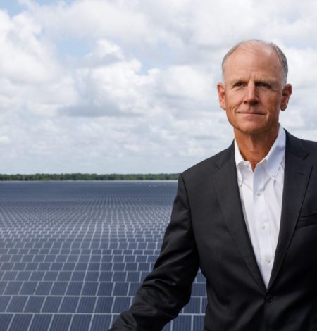 Syd Kitson at Solar Ranch on tower in front of 840-acre solar field